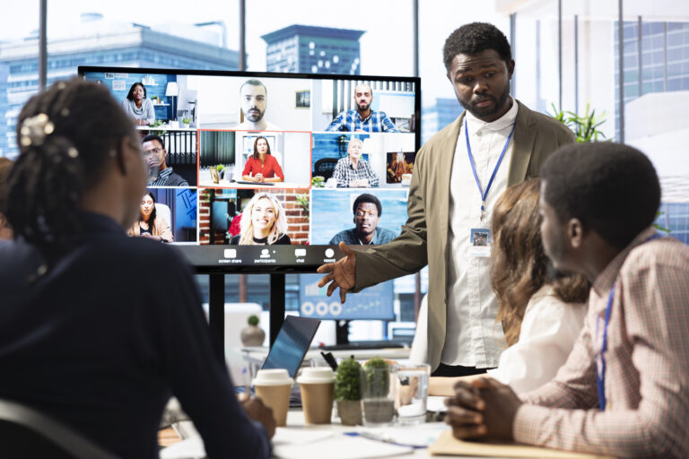 Company employees attending a meeting via videocall with investors