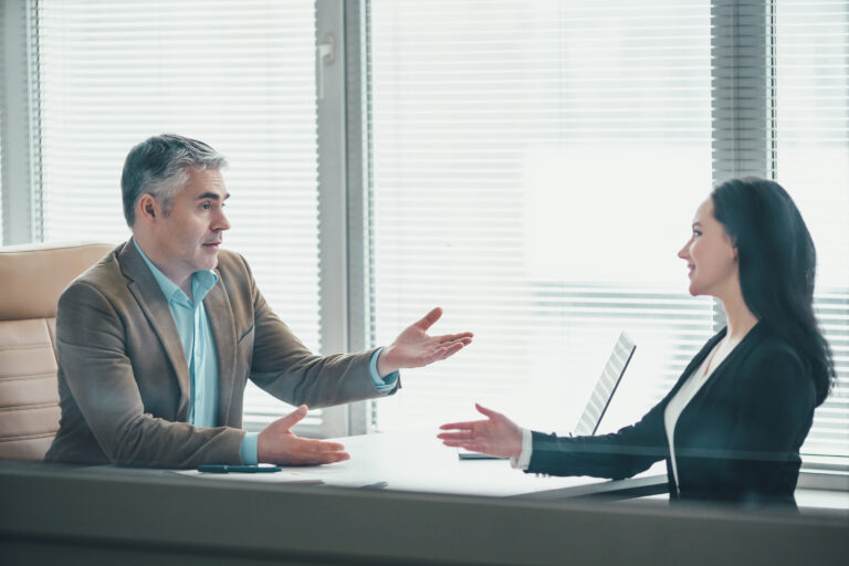 The business man and a woman discussing at the office table