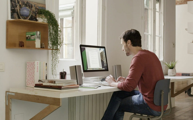 Un collaborateur travaille à distance depuis son bureau à domicile